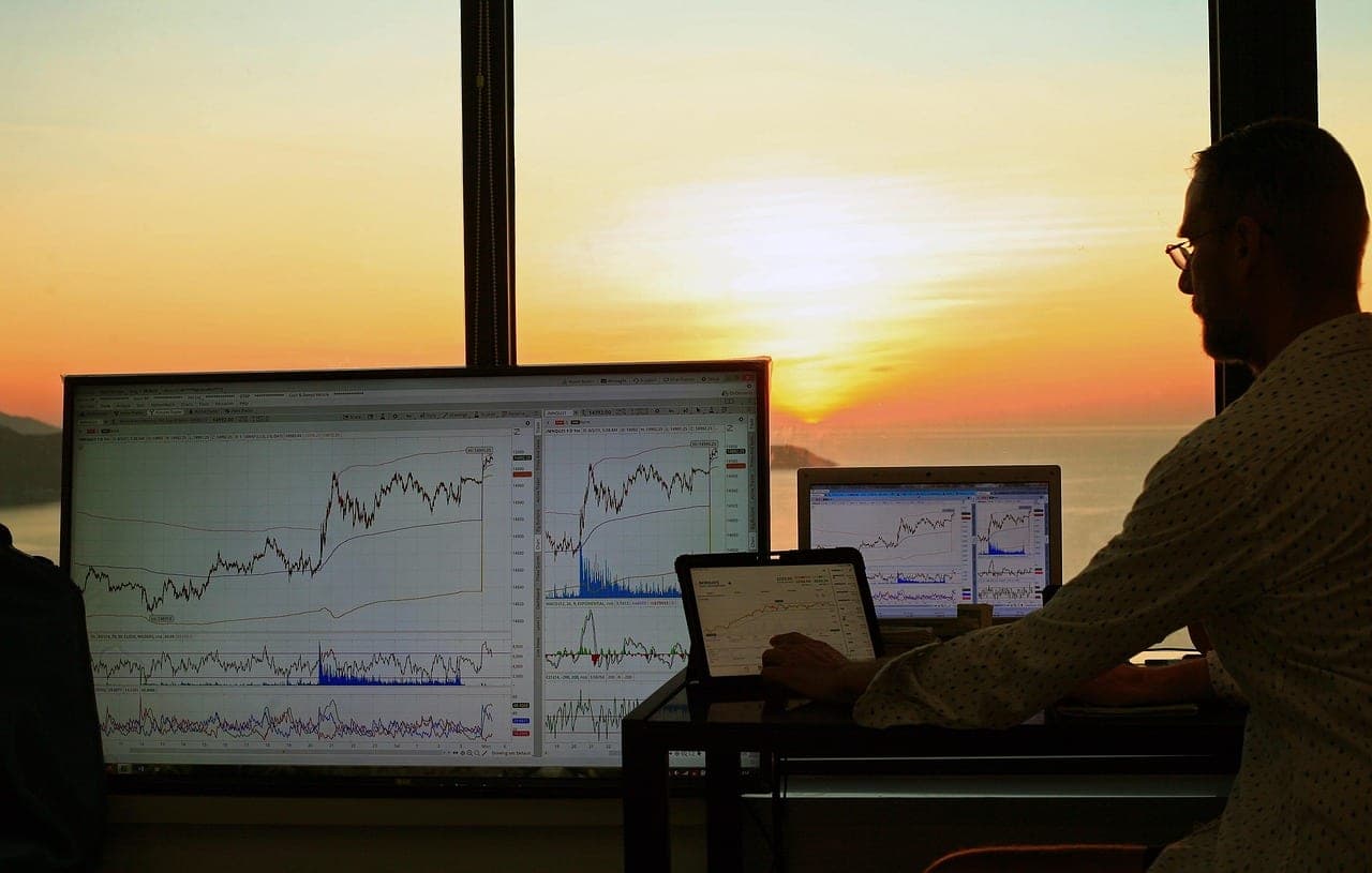 Laptop displaying marketing analytics and charts on a wooden desk