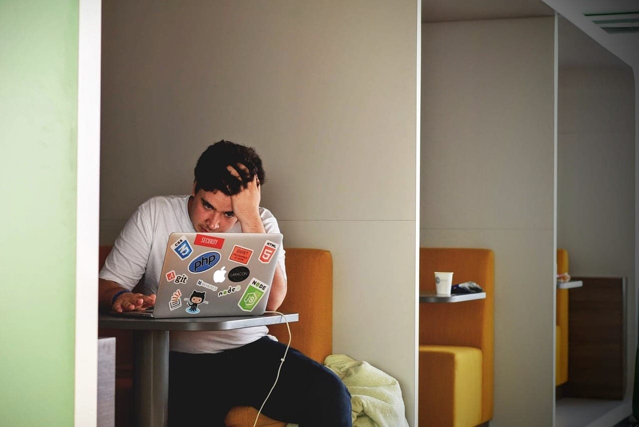 Stressed business owner looking at a laptop screen