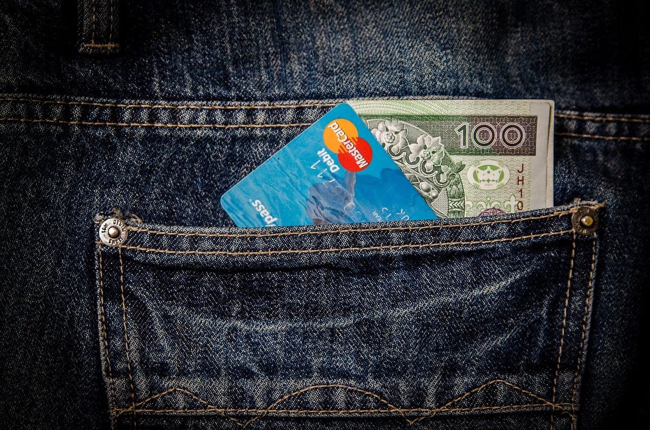 Typing on a keyboard next to a credit card