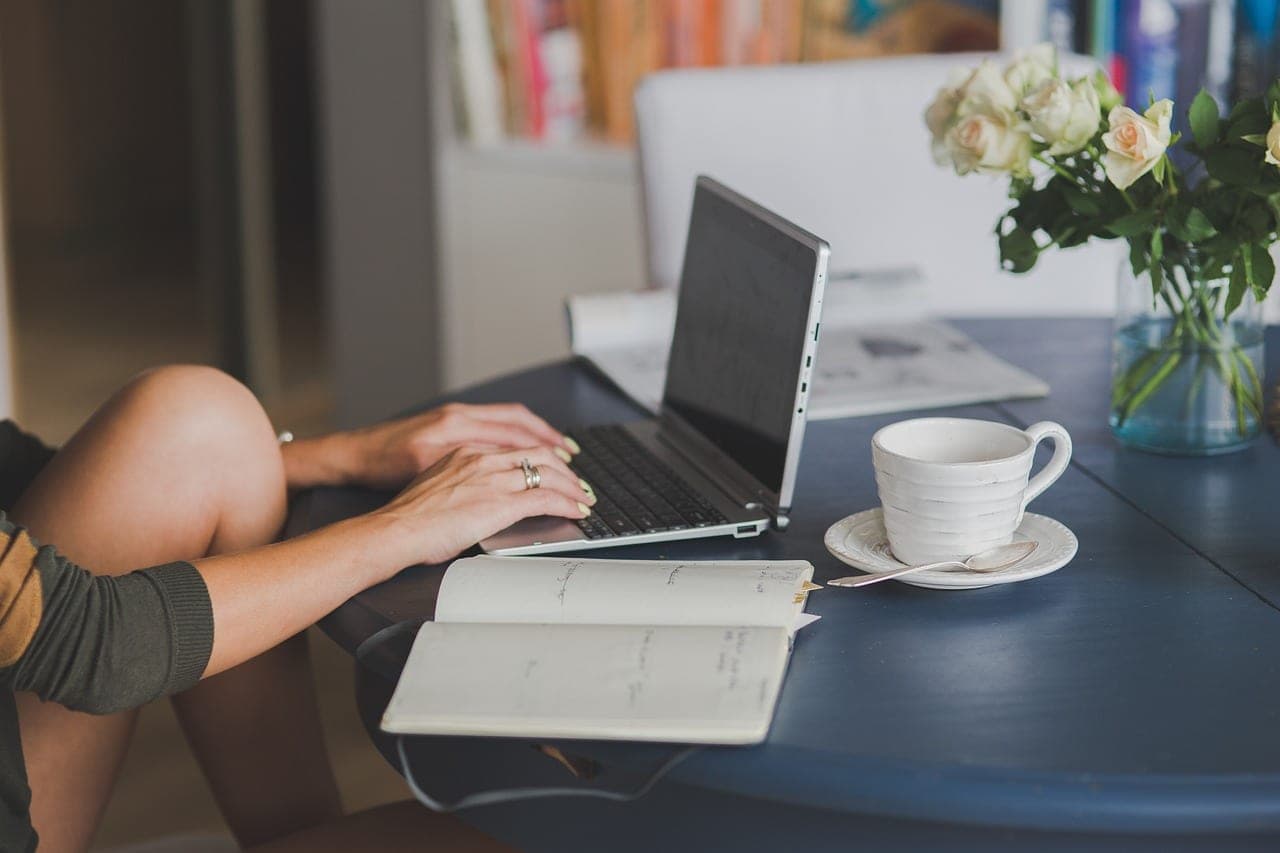 A clean workspace with a laptop and notepad for planning an SEO strategy.