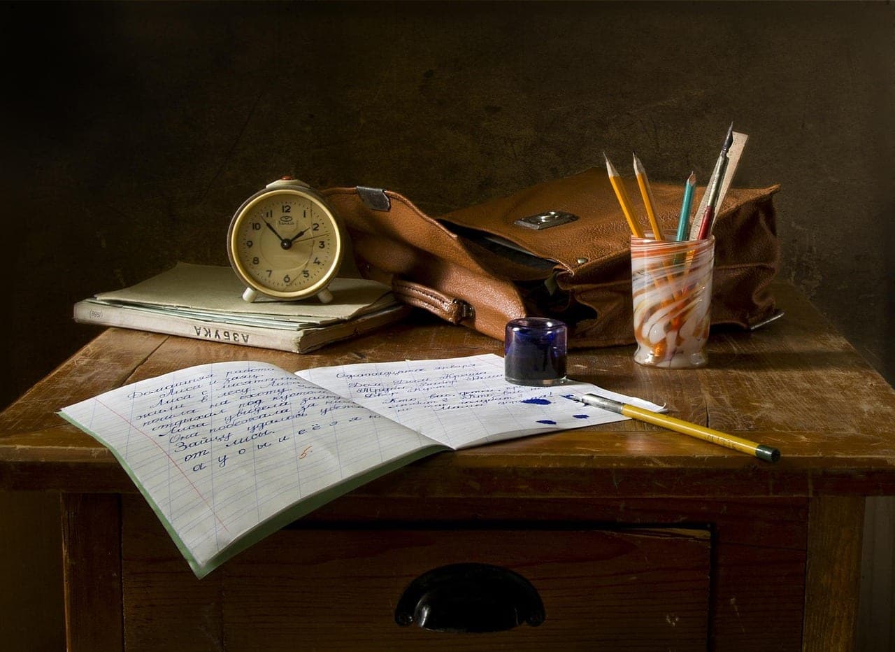 Contract paperwork and notes sitting on a wooden desk