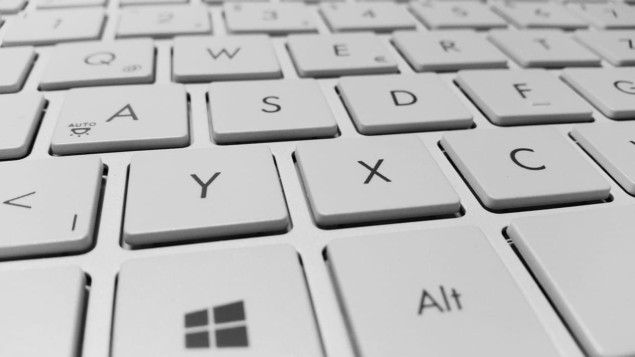Practitioner typing optimization briefs on a computer keyboard